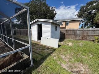 963 Brookview Lane Rockledge, FL 32955 - Photo 13 of 14 a view of backyard with small cabin and wooden fence