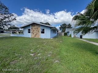 963 Brookview Lane Rockledge, FL 32955 - Photo 14 of 14 a large white house with a big yard and large trees