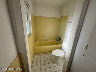 963 Brookview Lane Rockledge, FL 32955 - Photo 4 of 14 a bathroom with a sink a toilet a window and a bathtub