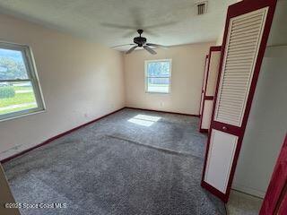 963 Brookview Lane Rockledge, FL 32955 - Photo 9 of 14 an empty room with windows and fan