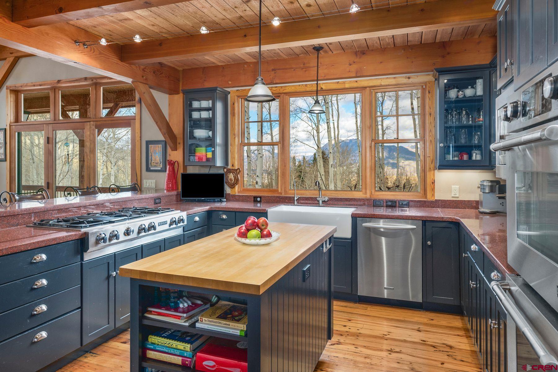 796 Red Mountain Ranch Road Crested Butte, CO 81224 - Photo 14 of 45 a kitchen that has a sink a stove and a table in it