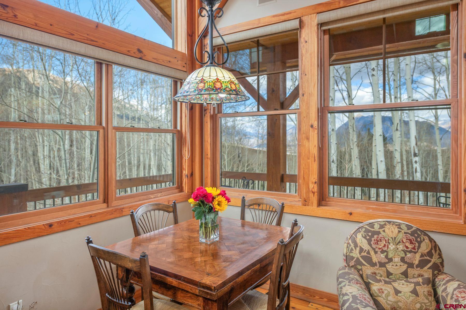 796 Red Mountain Ranch Road Crested Butte, CO 81224 - Photo 15 of 45 a dining room with furniture a chandelier and wooden floor