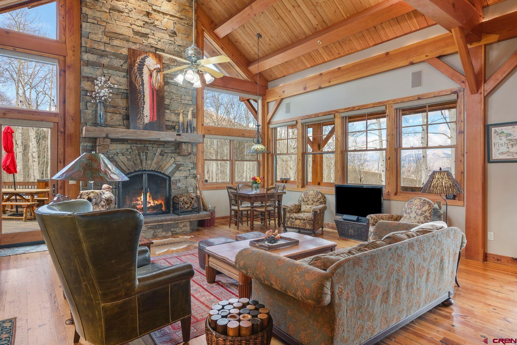 796 Red Mountain Ranch Road Crested Butte, CO 81224 - Photo 17 of 45 a living room with furniture a fireplace and large windows
