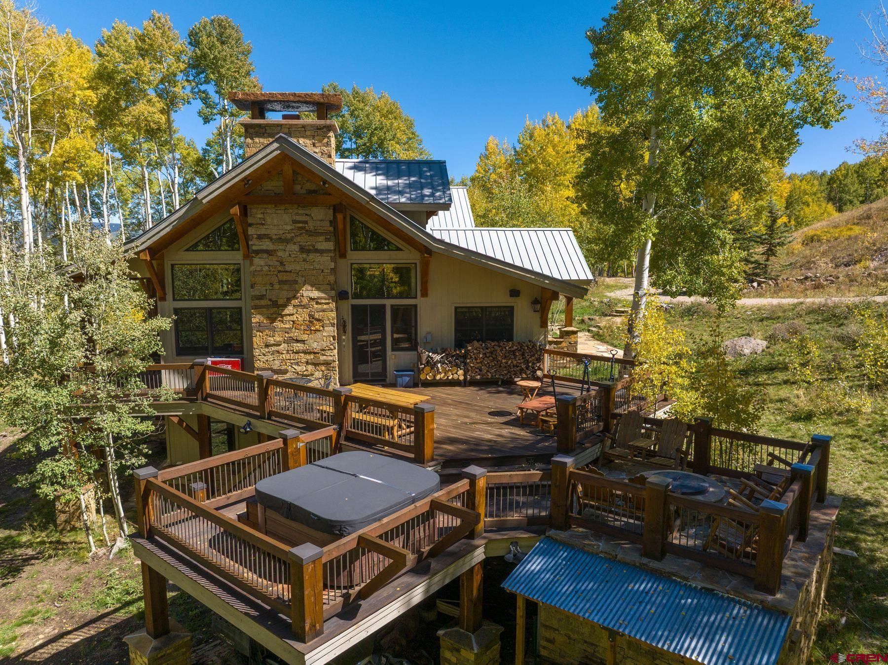 796 Red Mountain Ranch Road Crested Butte, CO 81224 - Photo 19 of 45 a roof deck with table and chairs under an umbrella