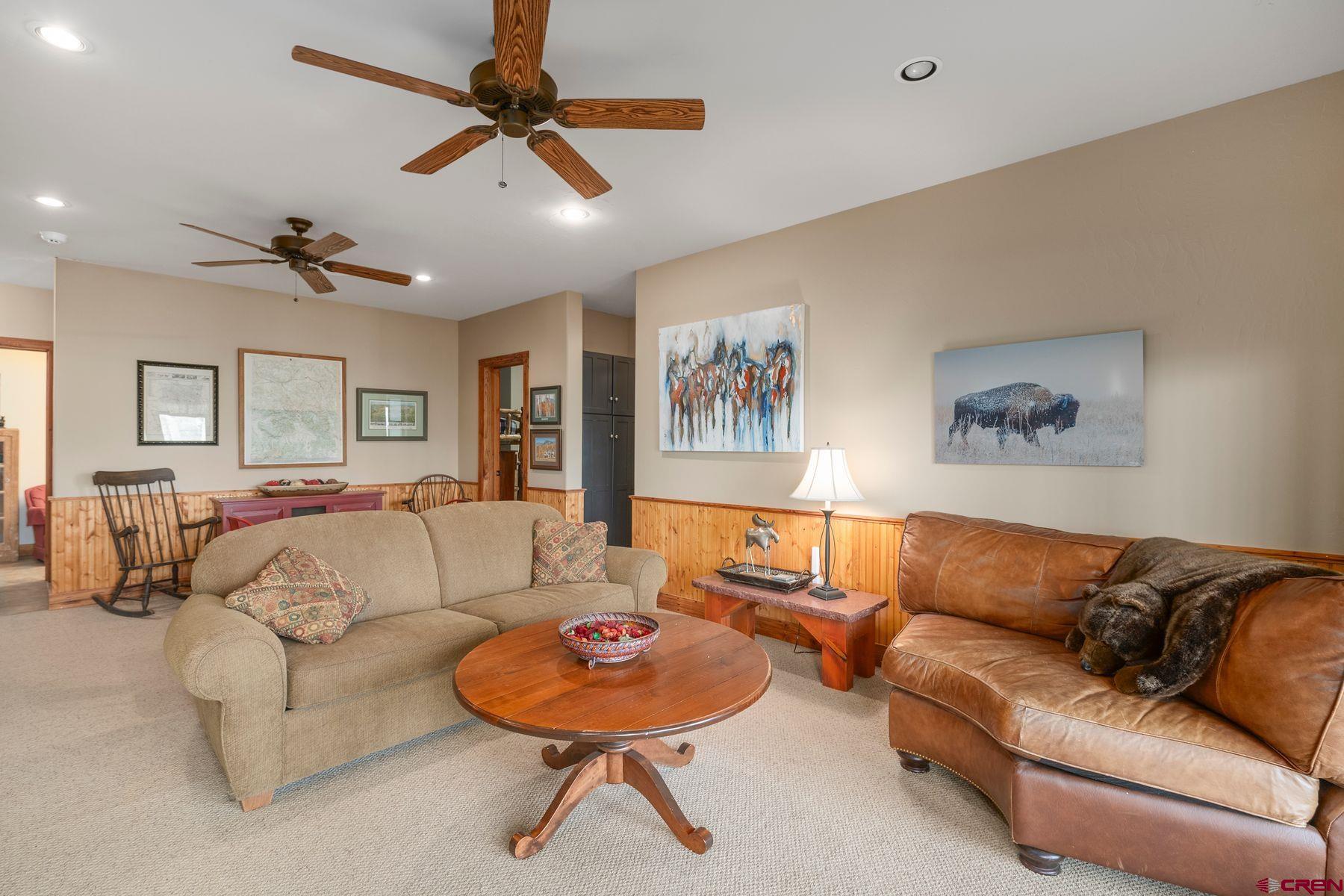 796 Red Mountain Ranch Road Crested Butte, CO 81224 - Photo 25 of 45 a living room with furniture kitchen and a chandelier