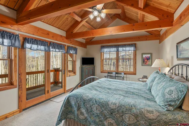 a bedroom with furniture and a chandelier