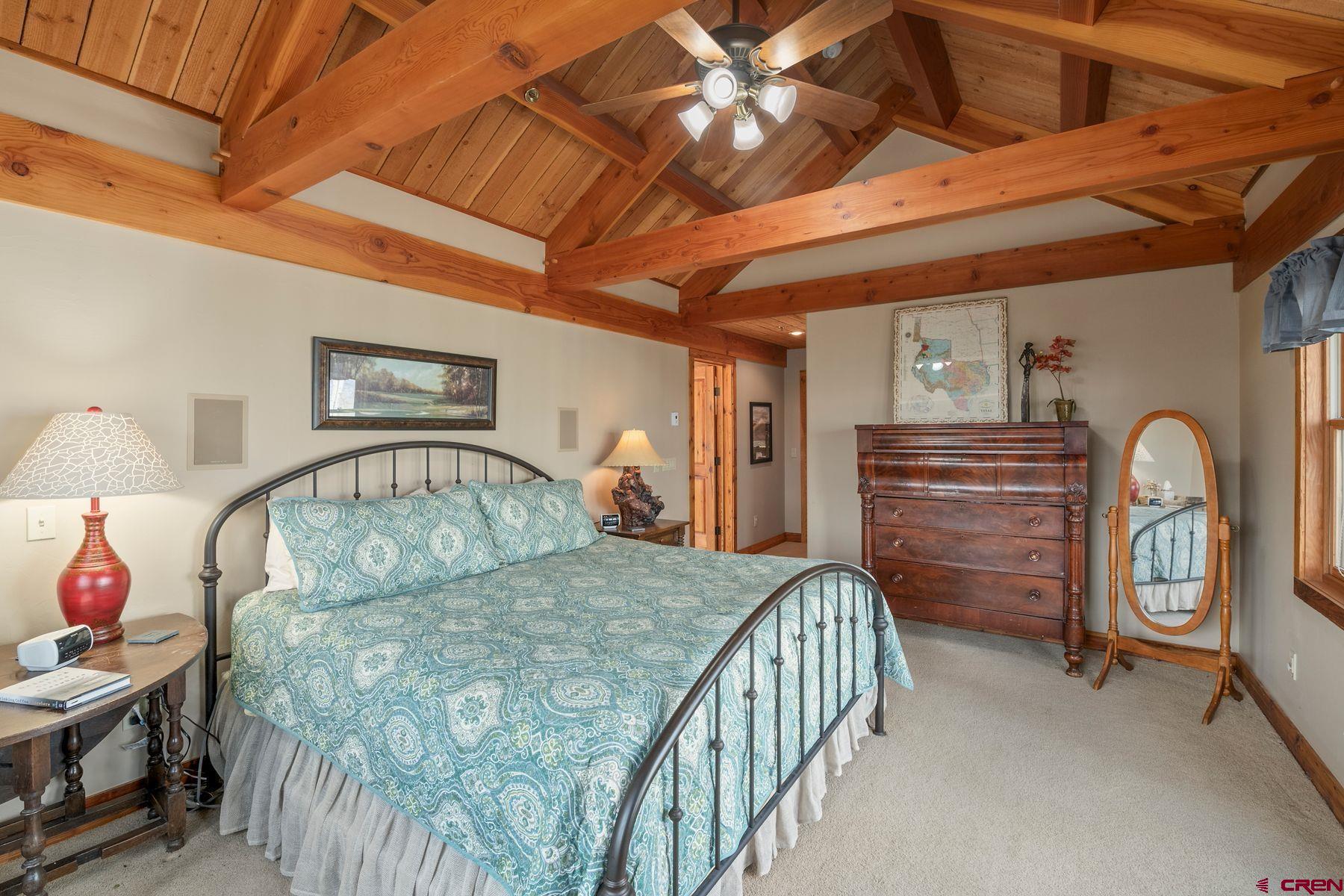 796 Red Mountain Ranch Road Crested Butte, CO 81224 - Photo 28 of 45 a bedroom with furniture and a chandelier