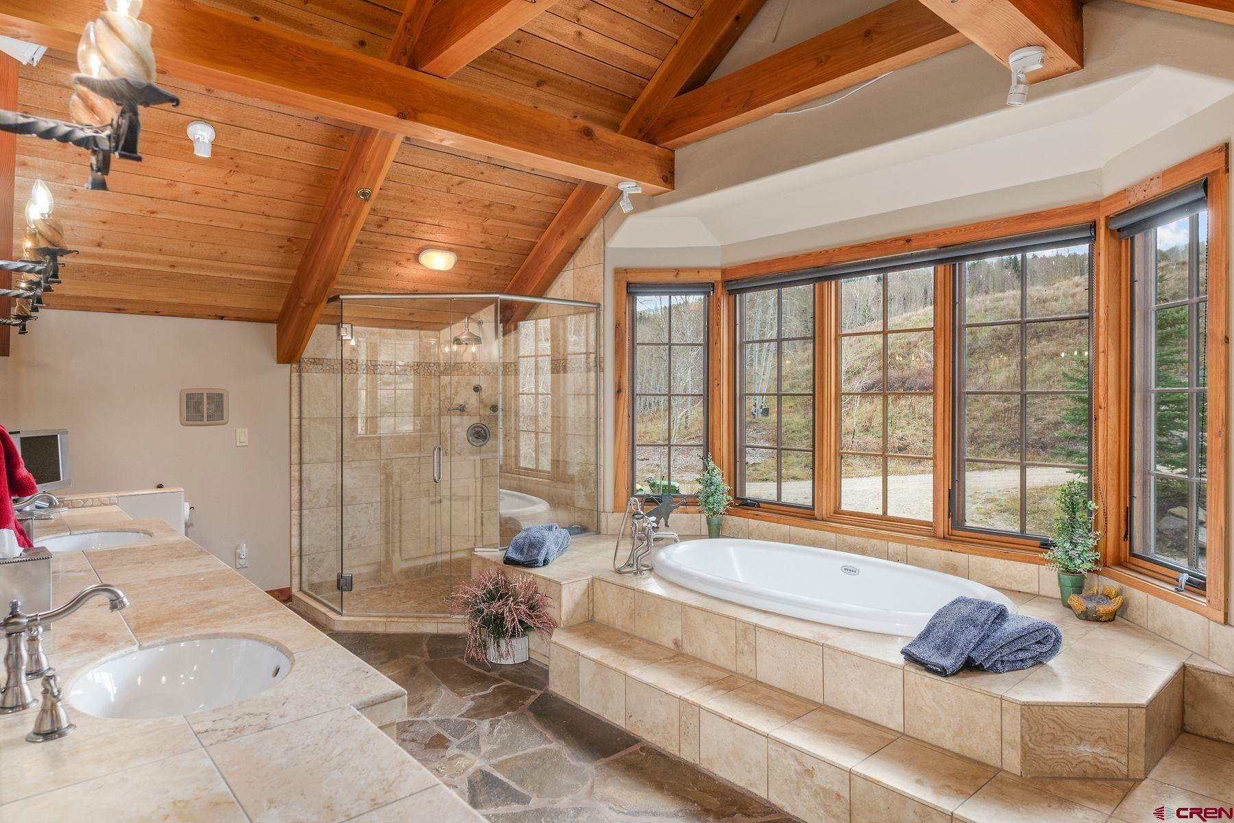 796 Red Mountain Ranch Road Crested Butte, CO 81224 - Photo 29 of 45 a spacious bathroom with a tub and large windows