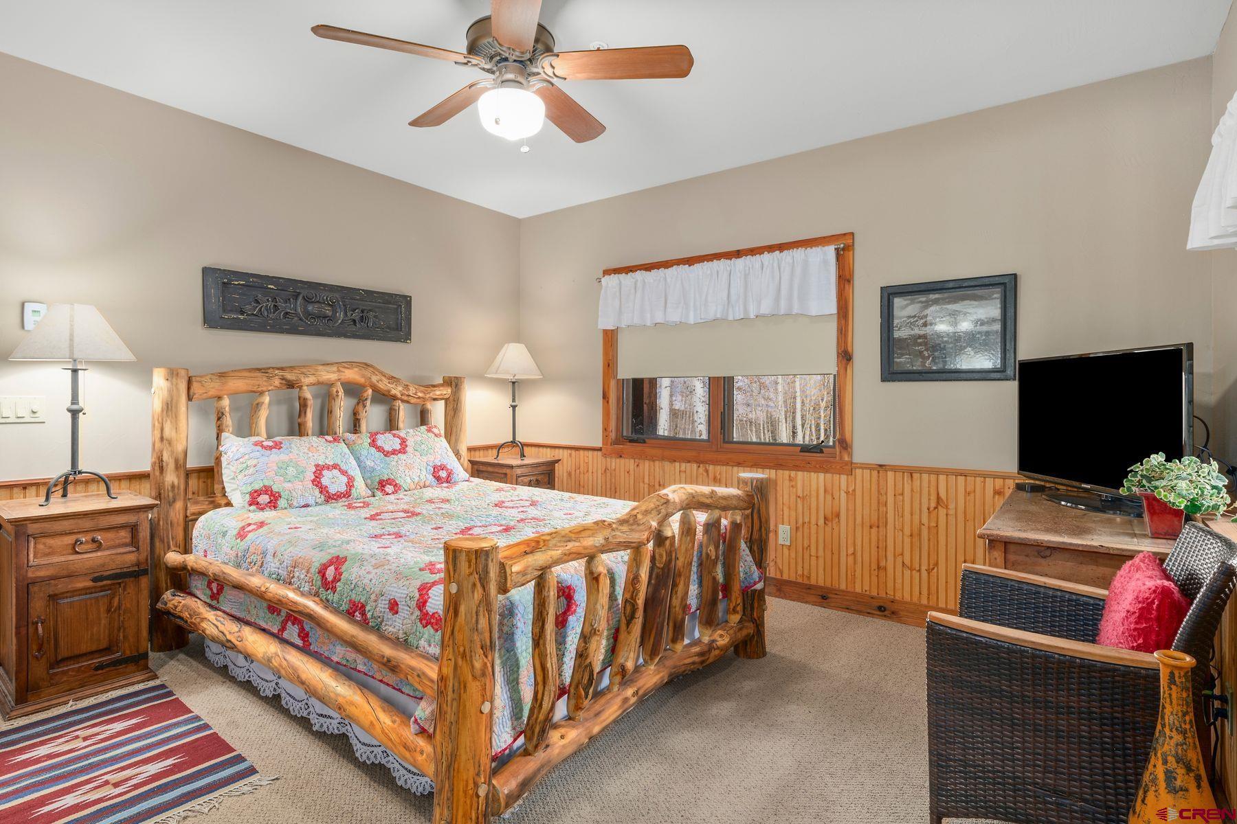 796 Red Mountain Ranch Road Crested Butte, CO 81224 - Photo 31 of 45 a bedroom with a bed and a flat screen tv