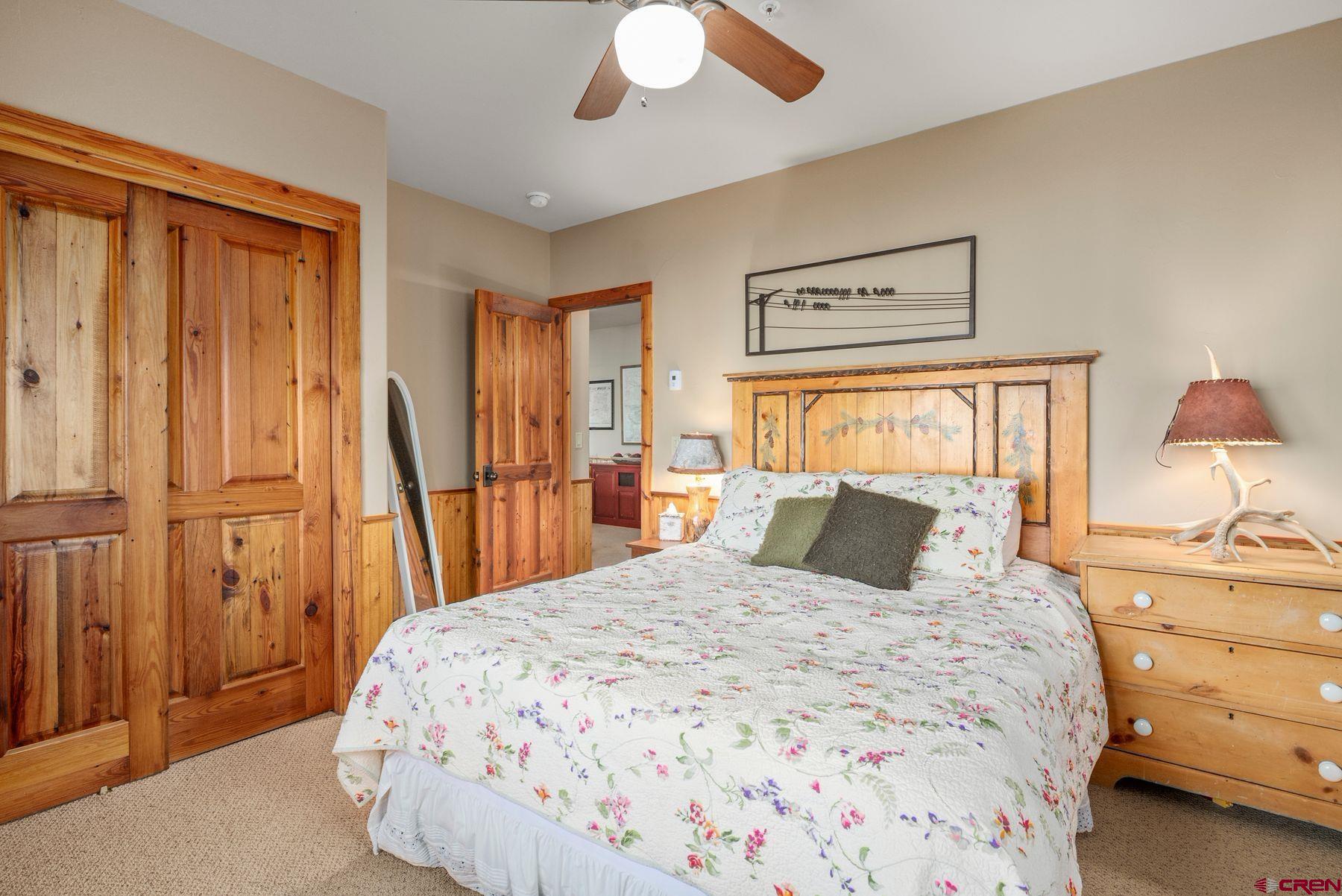 796 Red Mountain Ranch Road Crested Butte, CO 81224 - Photo 33 of 45 a bedroom with a bed and a chandelier
