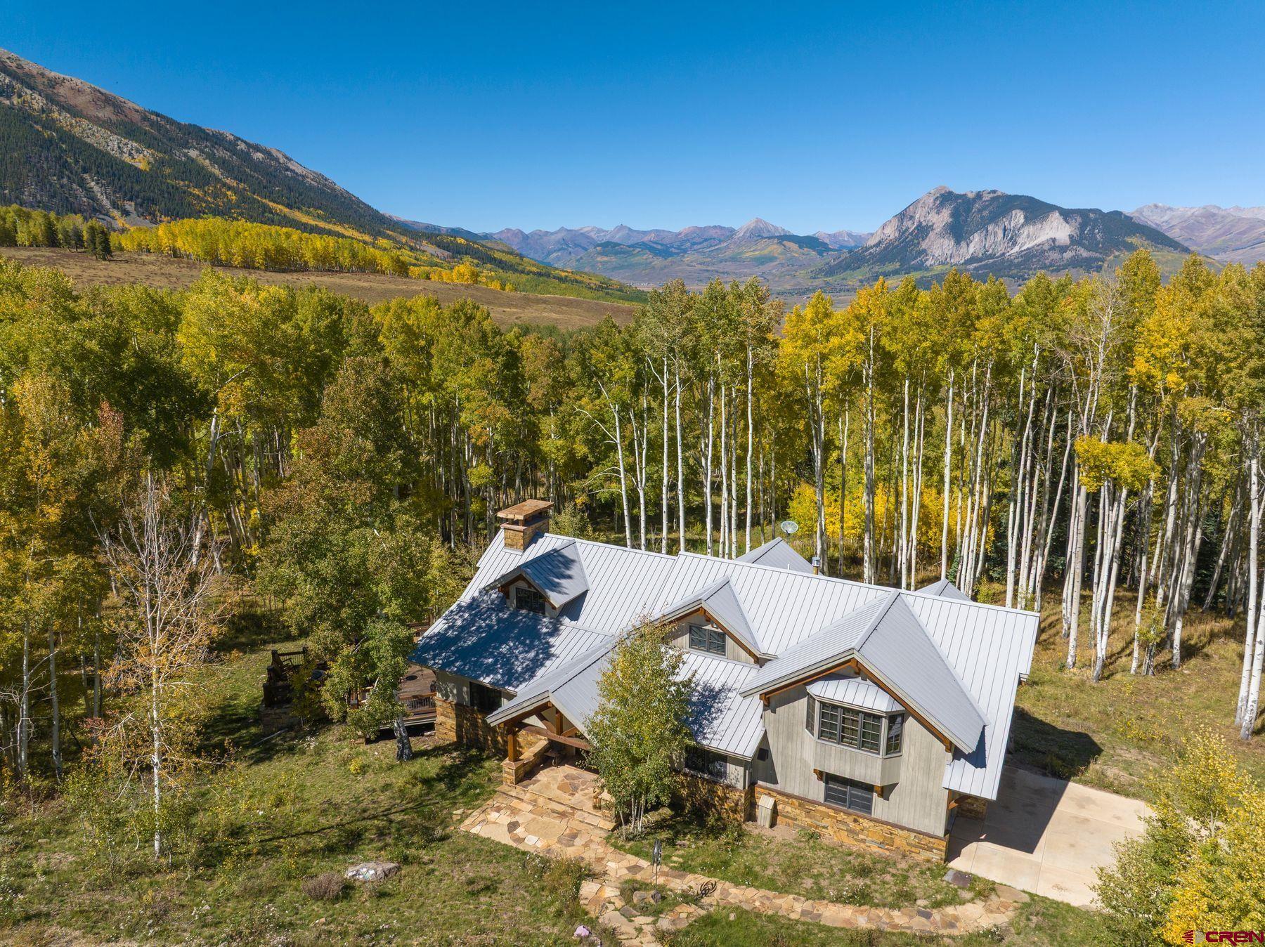 796 Red Mountain Ranch Road Crested Butte, CO 81224 - Photo 37 of 45 a view of a patio with a table under an umbrella