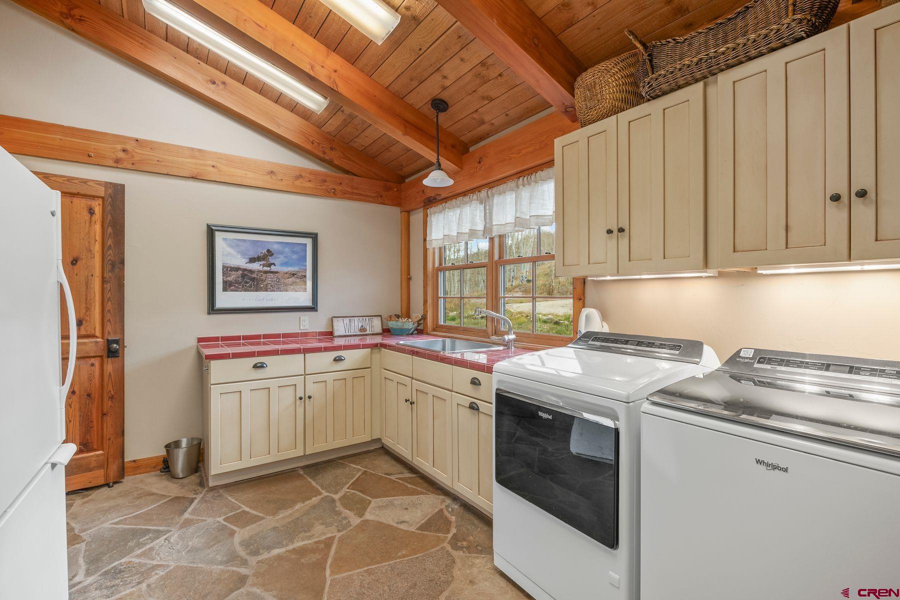 796 Red Mountain Ranch Road Crested Butte, CO 81224 - Photo 39 of 45 a kitchen with stainless steel appliances granite countertop a sink stove and refrigerator
