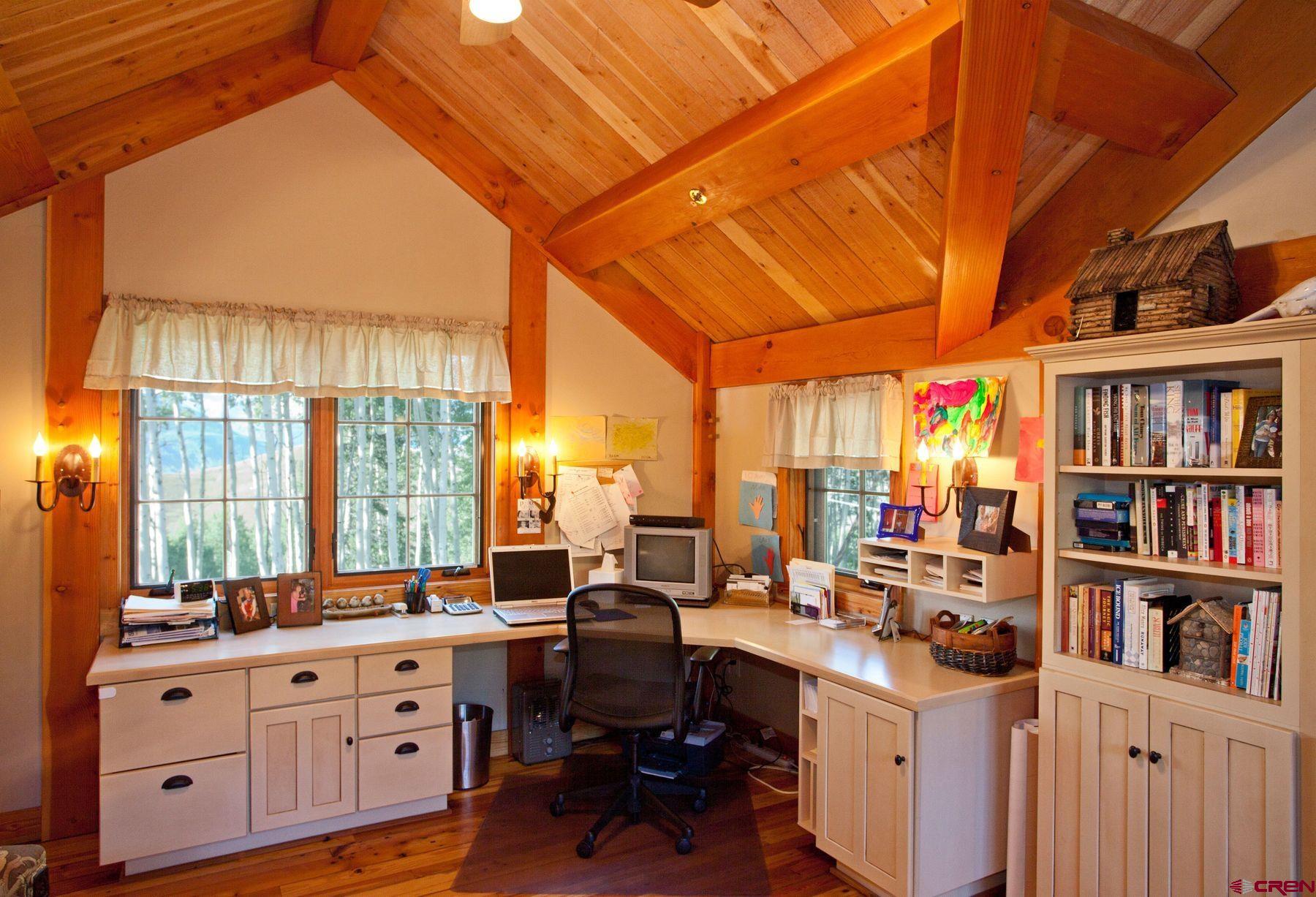 796 Red Mountain Ranch Road Crested Butte, CO 81224 - Photo 41 of 45 a room with furniture a bookshelf and a large window