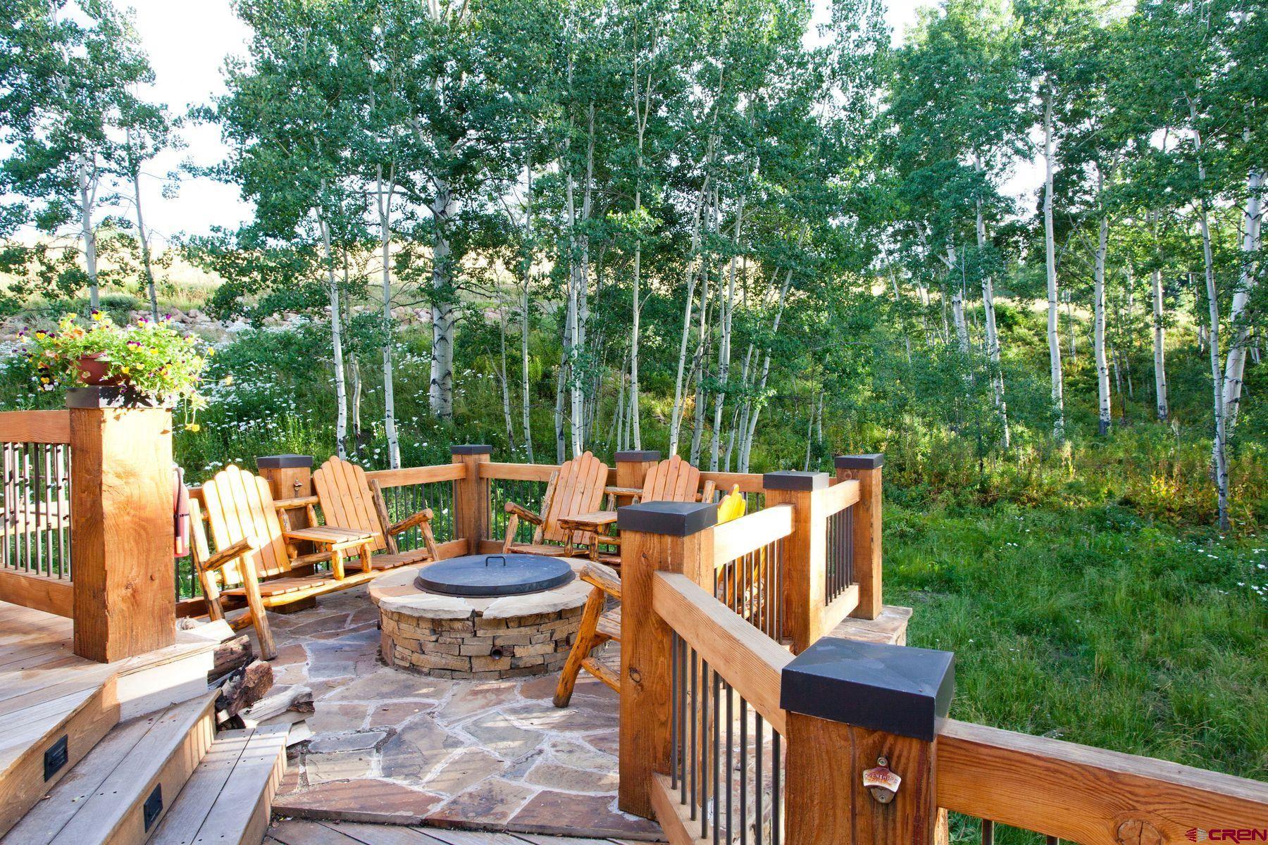 796 Red Mountain Ranch Road Crested Butte, CO 81224 - Photo 44 of 45 a view of a patio with table and chairs and a large tree