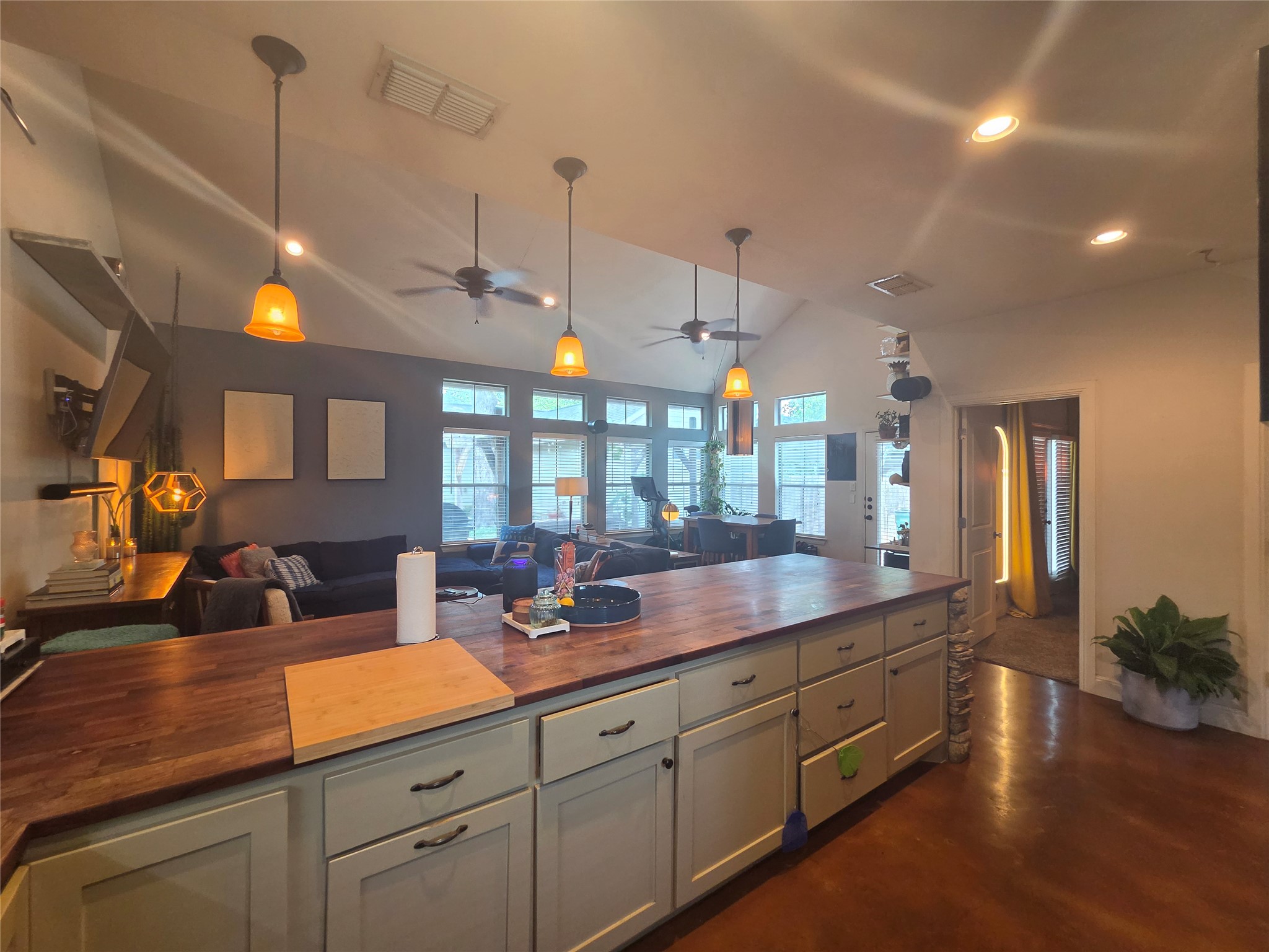 408 West Croslin Street Austin, TX 78752 - Photo 2 of 29 An inviting open-concept layout unites the kitchen and living areas, offering effortless entertaining possibilities.