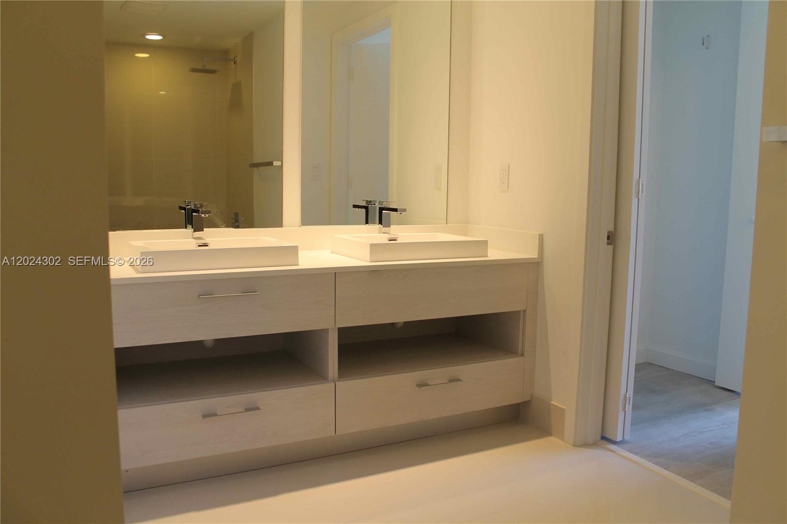 45 Southwest 9th Street, Unit 2109 Miami, FL 33130 - Photo 10 of 40 a bathroom with a sink and a mirror