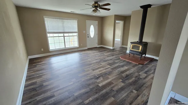 a kitchen with stainless steel appliances a sink a stove a refrigerator cabinets and wooden floor