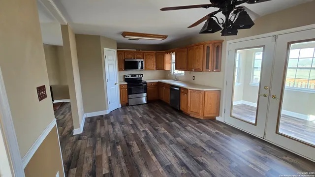 a kitchen with stainless steel appliances granite countertop a stove microwave and sink