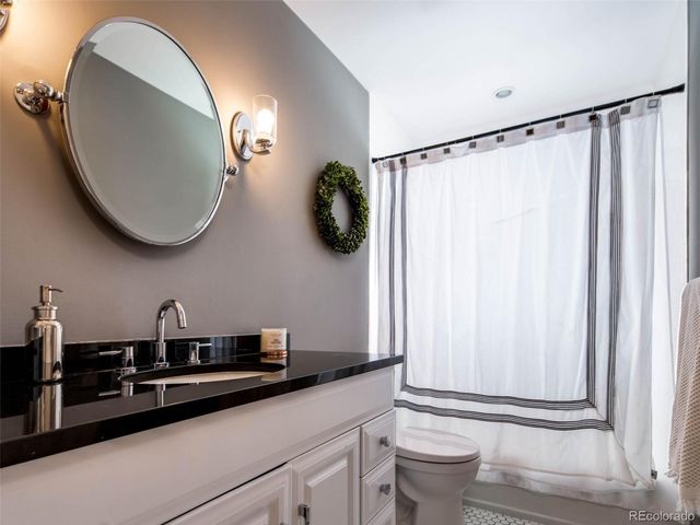 a bedroom with a bed and dresser with window