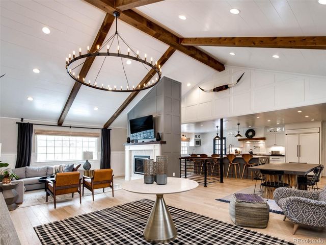 a living room with lots of furniture and kitchen view