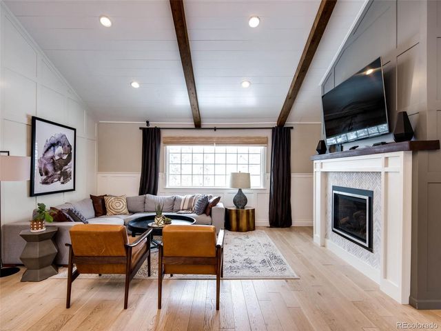 a living room with furniture fireplace and flat screen tv