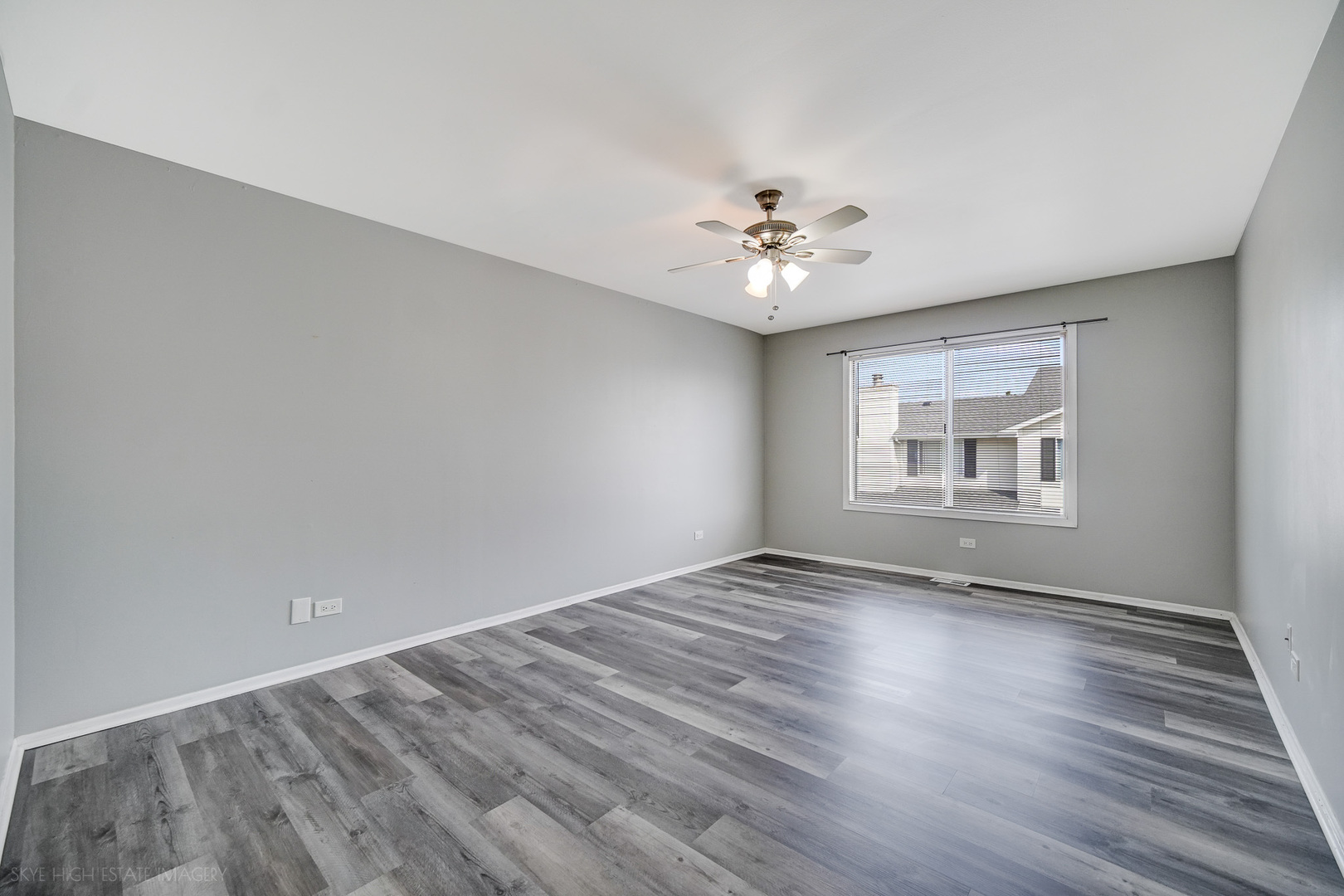 103 Red Barn Road, Unit 103 Matteson, IL 60443 - Photo 12 of 17 a view of an empty room with a window and wooden floor
