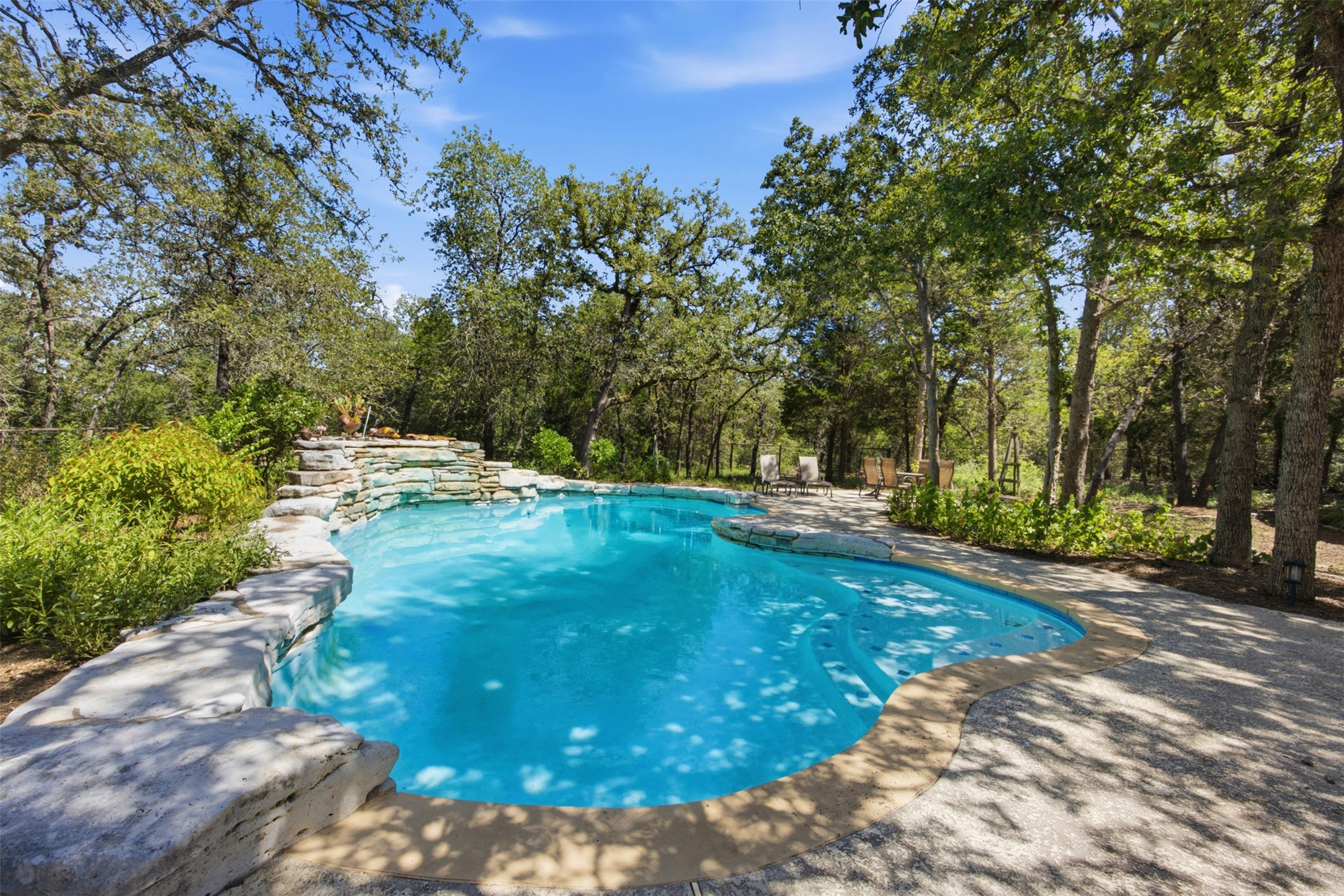 197 Elm Wood Drive Elgin, TX 78621 - Photo 25 of 37 Discover a tranquil outdoor haven with a naturally inspired swimming pool, perfect for relaxation and recreation.