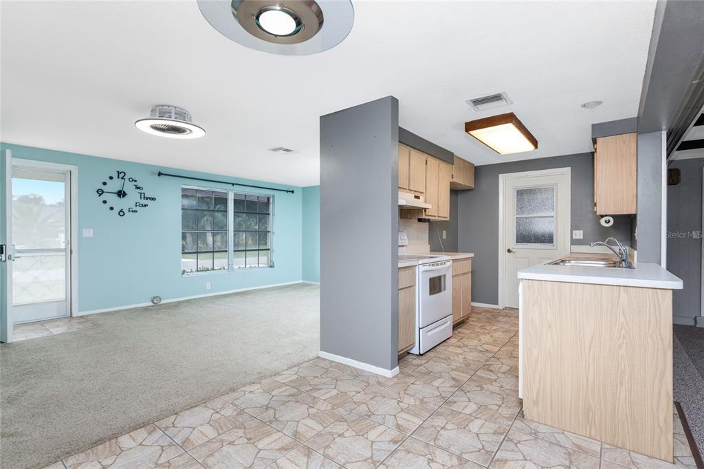442 Kostner Street Port Charlotte, FL 33954 - Photo 14 of 69 a view of a kitchen with a sink cabinets and a window