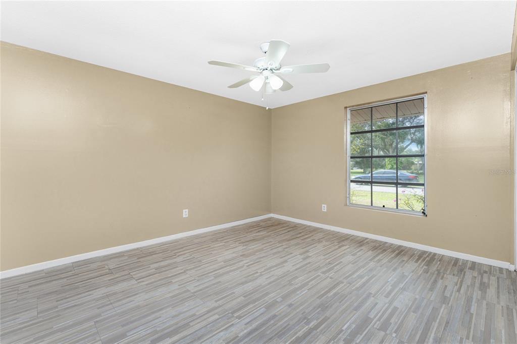 442 Kostner Street Port Charlotte, FL 33954 - Photo 26 of 69 wooden floor in an empty room with a window