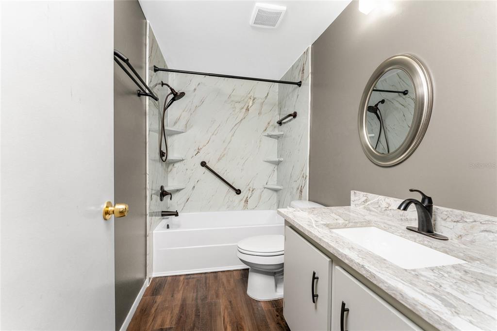442 Kostner Street Port Charlotte, FL 33954 - Photo 28 of 69 a bathroom with a granite countertop sink a toilet and a bathtub