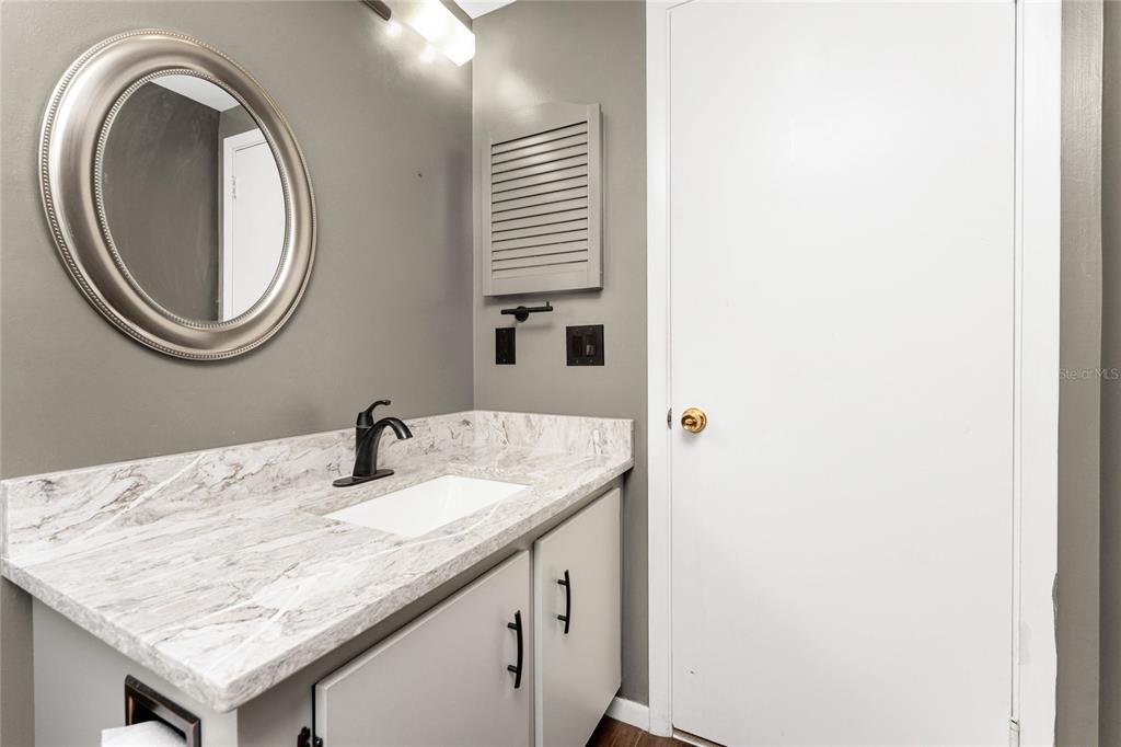 442 Kostner Street Port Charlotte, FL 33954 - Photo 30 of 69 a bathroom with a granite countertop sink and a mirror