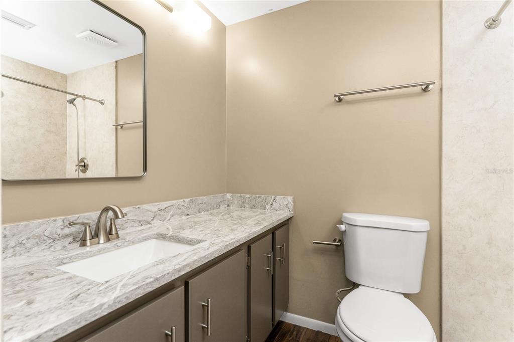 442 Kostner Street Port Charlotte, FL 33954 - Photo 35 of 69 a bathroom with a granite countertop sink mirror vanity and toilet