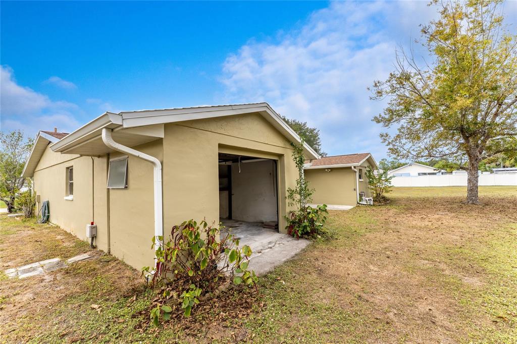 442 Kostner Street Port Charlotte, FL 33954 - Photo 46 of 69 a view of a house with a yard and large tree