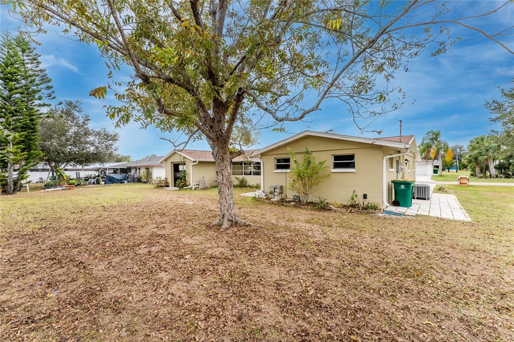 442 Kostner Street Port Charlotte, FL 33954 - Photo 51 of 69 a front view of a house with a yard and garage
