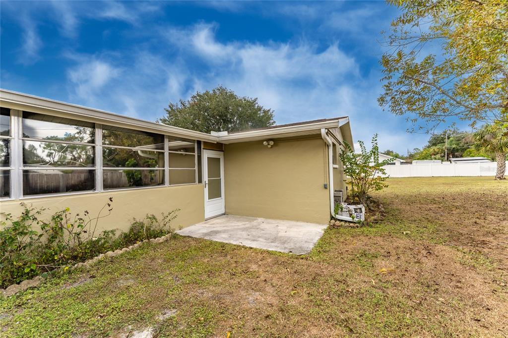 442 Kostner Street Port Charlotte, FL 33954 - Photo 6 of 69 a front view of a house with a yard