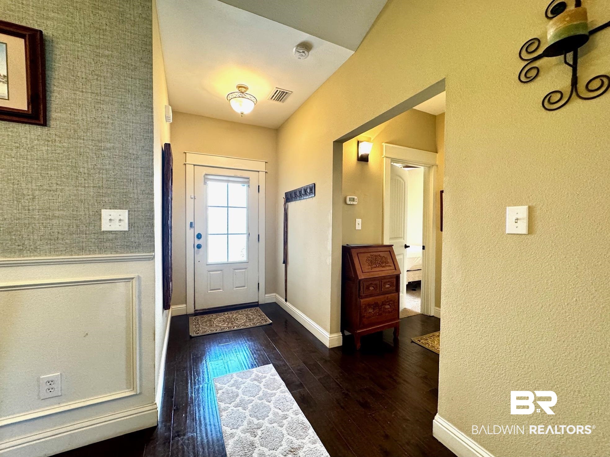 1030 Crown Walk Drive Foley, AL 36535 - Photo 19 of 40 Foyer with visible vents, baseboards, dark wood-type flooring, and a wainscoted wall