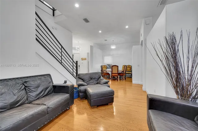 a living room with furniture and a kitchen