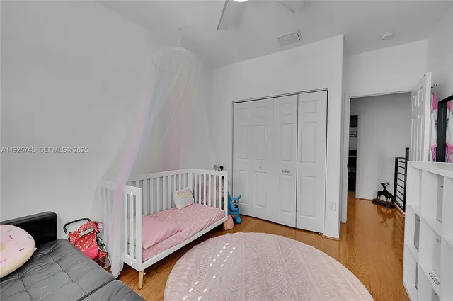 a spacious bedroom with a bed and a large window