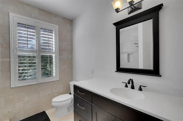 a bathroom with a granite countertop sink mirror and double