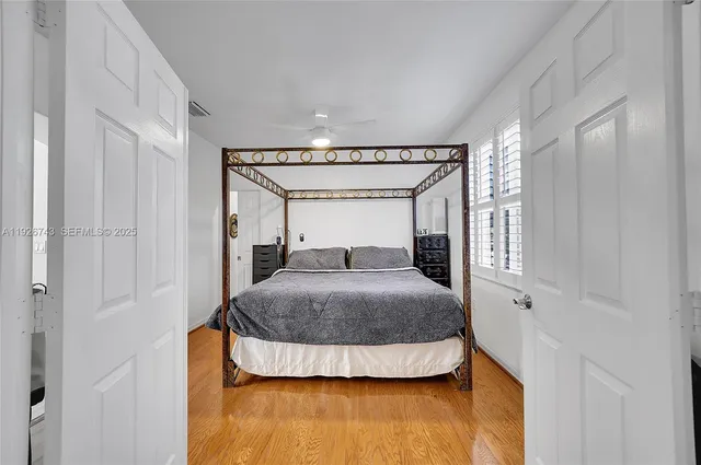 an aerial view of residential houses with outdoor space and trees