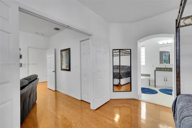 a front view of a house with a tree