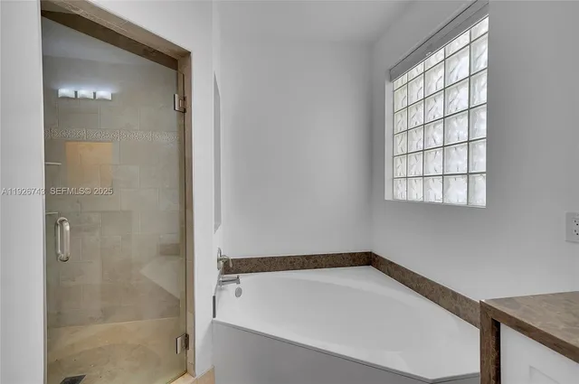 a front view of multi story residential apartment building with yard and sign board