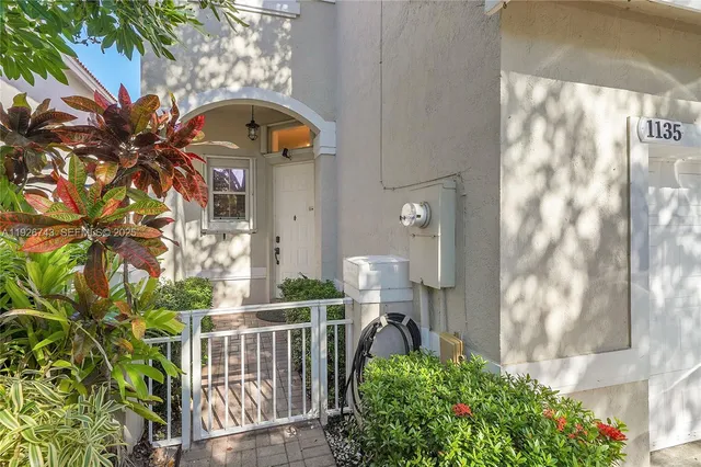 a utility room with dryer washer and a rug