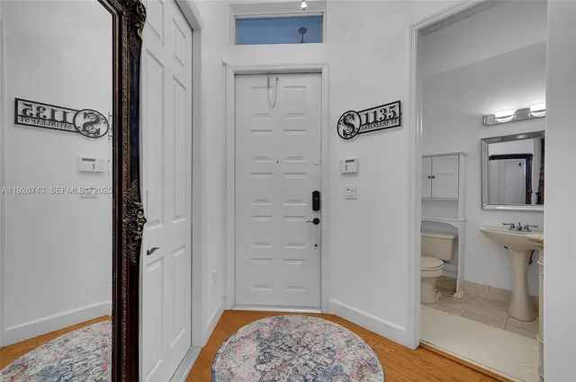 a living room with furniture and a large mirror