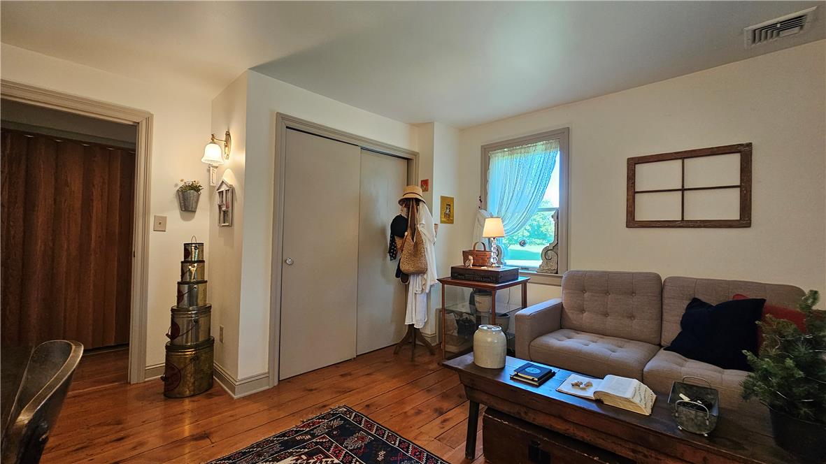 585 Buttermilk Road Hellertown, PA 18055 - Photo 33 of 82 Hardwood floors and a well-lit living area provide a welcoming atmosphere.