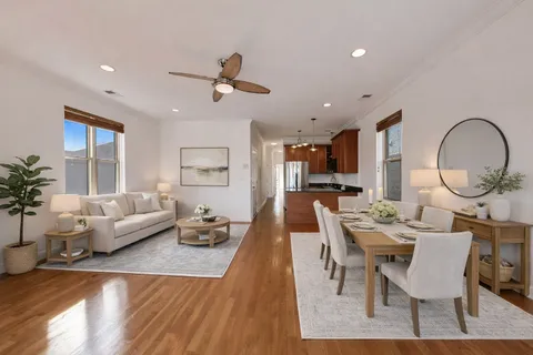 a living room with furniture a rug and a chandelier