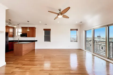a view of kitchen with stainless steel appliances granite countertop a stove top oven a sink and a refrigerator