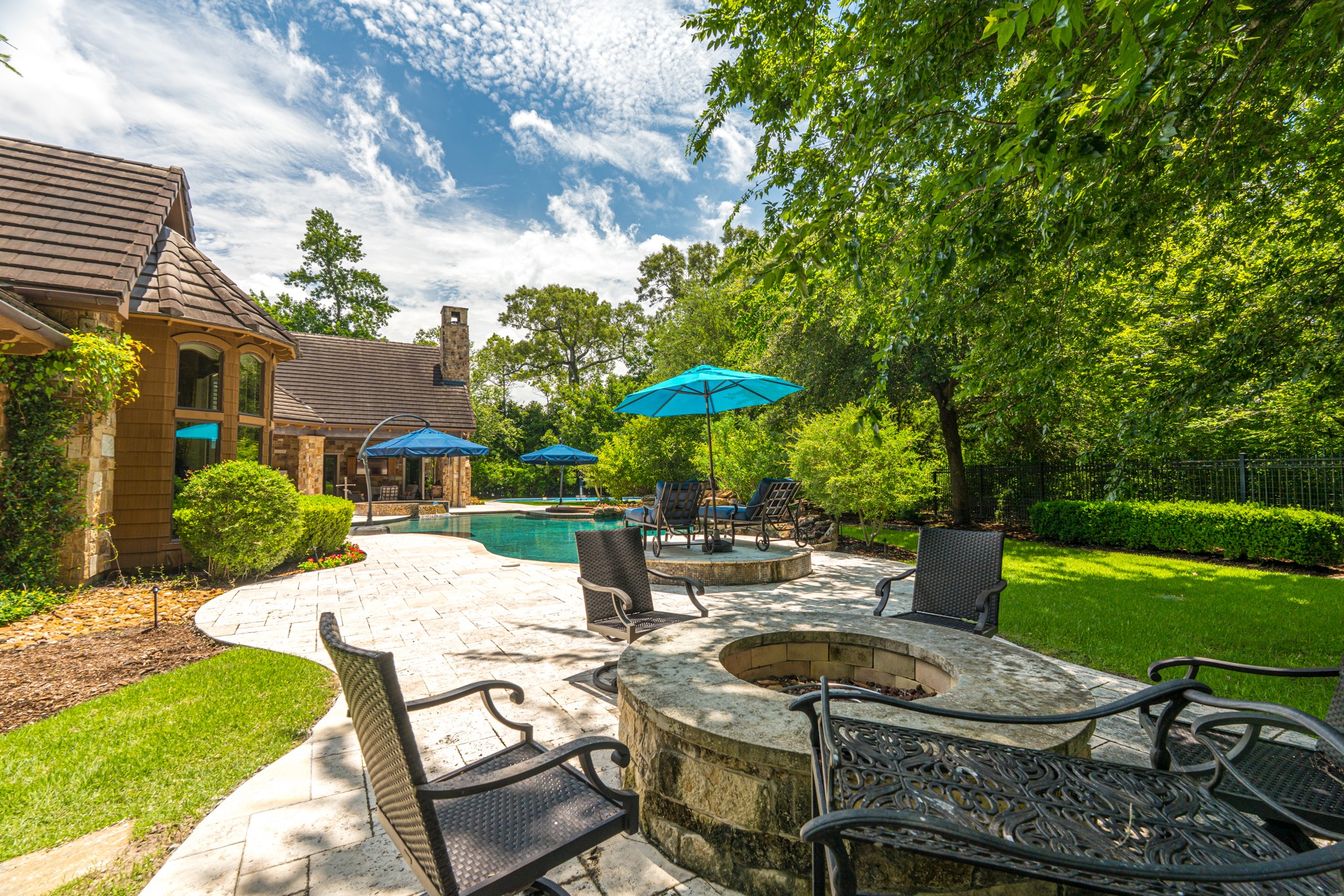 247 South Fazio Way Spring, TX 77389 - Photo 13 of 17 Gather, relax, and unwind in an exceptional outdoor living space complete with a custom fire pit, spacious patios, and tranquil surroundings.