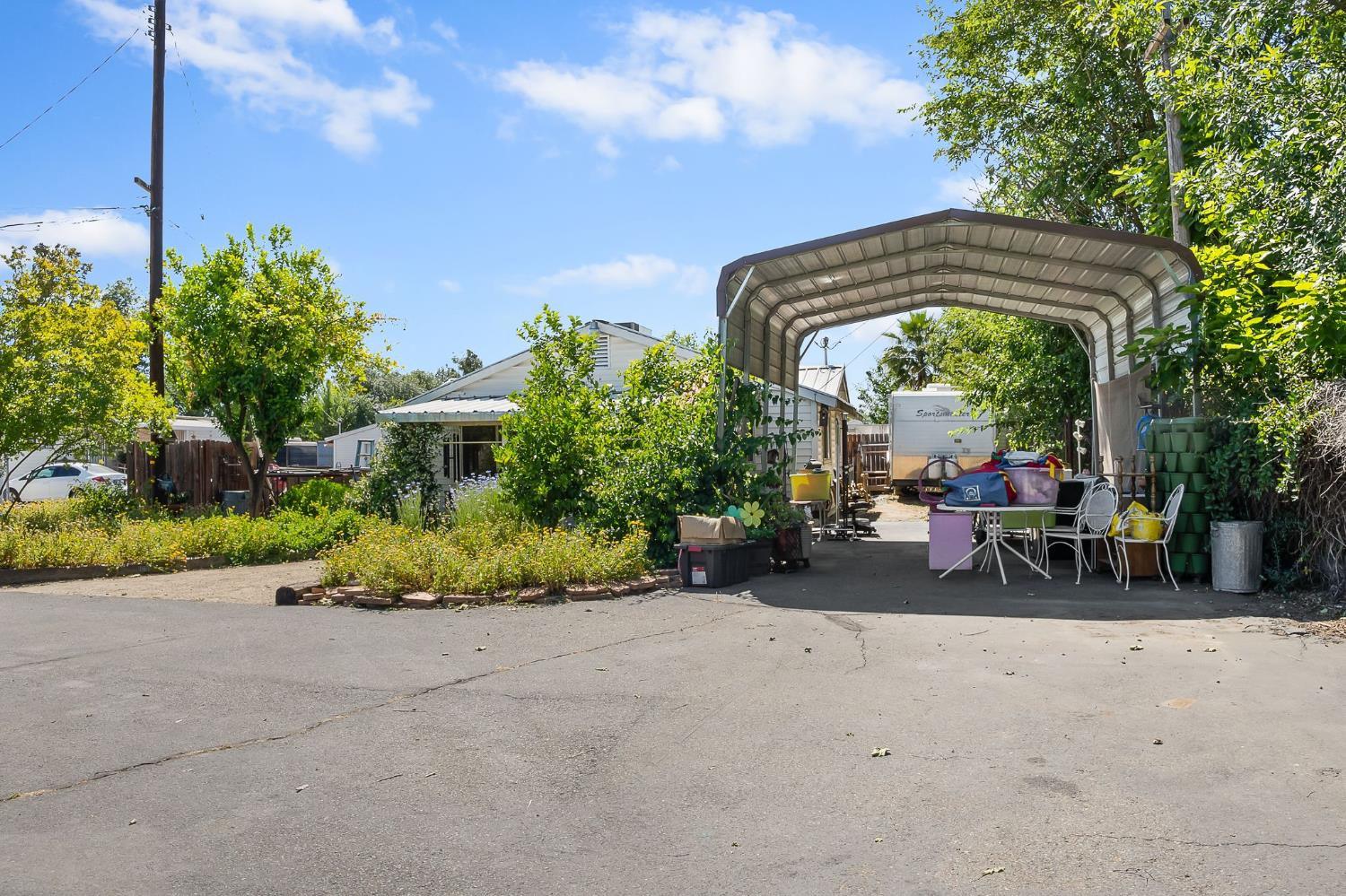 6837 Rio Linda Boulevard Rio Linda, CA 95673 - Photo 3 of 51 a view of a patio with table and chairs under an umbrella