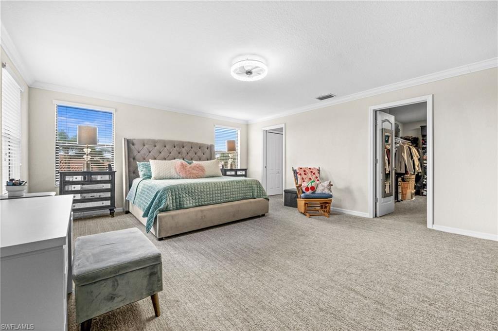 4754 Abaca Circle Naples, FL 34119 - Photo 20 of 46 a bedroom with a bed and a couch